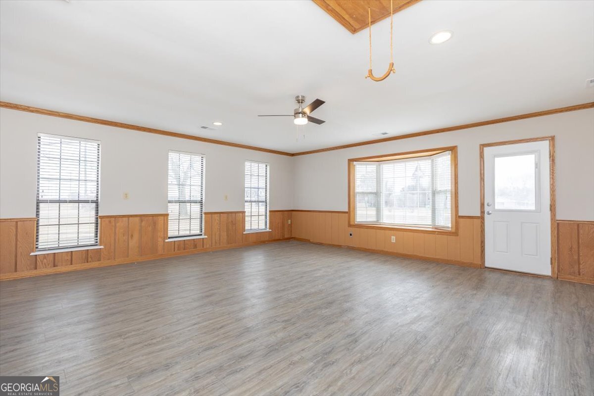 1027 Kathryn Ryals Road Warner Robins, GA 31088 - Photo 25 of 54 a view of an empty room with a window and wooden floor