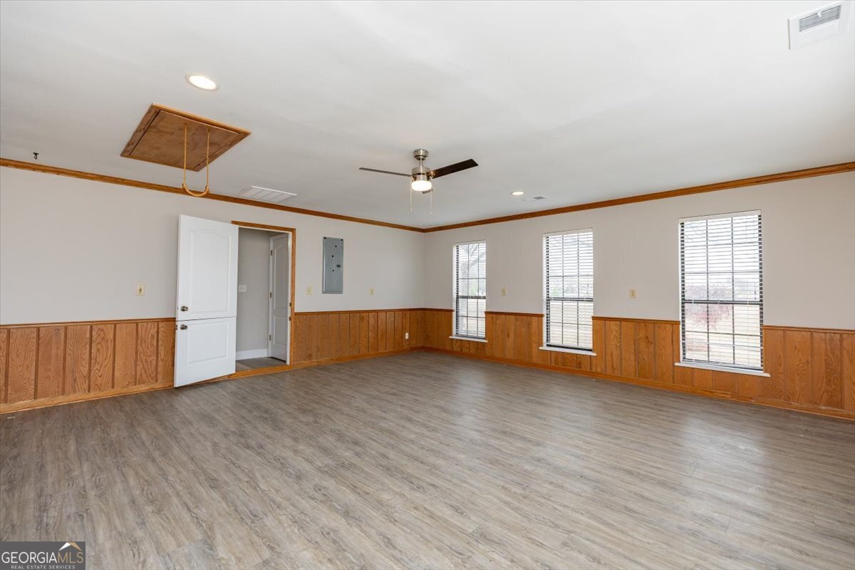 1027 Kathryn Ryals Road Warner Robins, GA 31088 - Photo 26 of 54 a view of empty room with wooden floor and fan