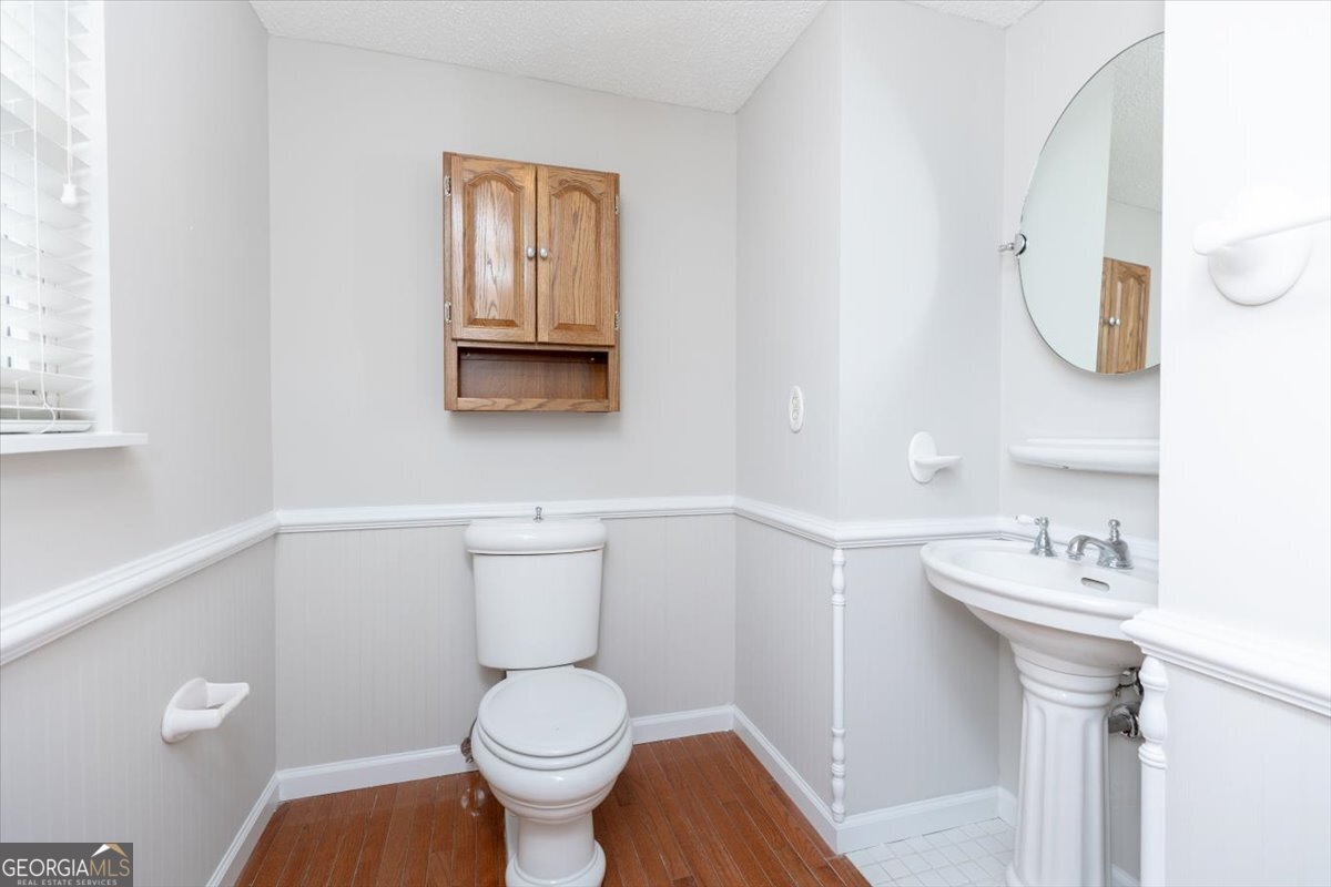 1027 Kathryn Ryals Road Warner Robins, GA 31088 - Photo 28 of 54 a bathroom with a toilet sink and mirror