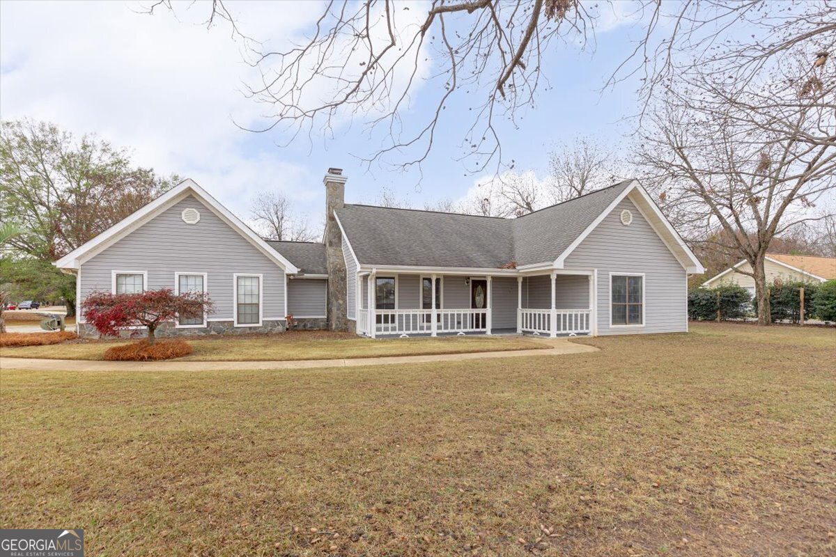 1027 Kathryn Ryals Road Warner Robins, GA 31088 - Photo 3 of 54 a front view of a house with a garden and trees
