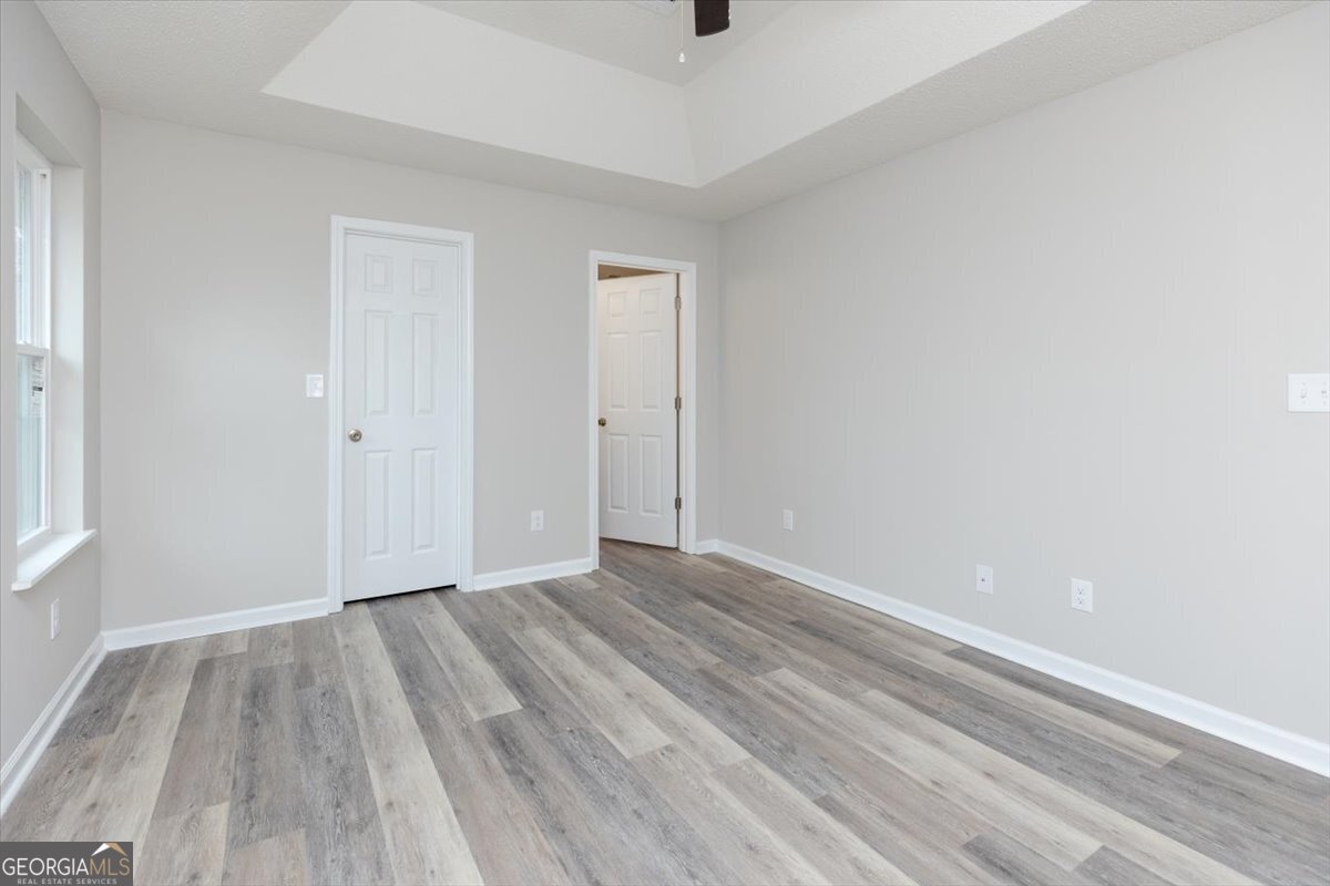 1027 Kathryn Ryals Road Warner Robins, GA 31088 - Photo 31 of 54 a view of an empty room with wooden floor and a window