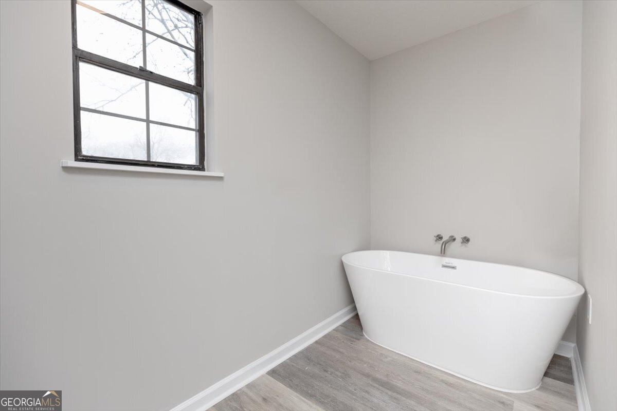 1027 Kathryn Ryals Road Warner Robins, GA 31088 - Photo 33 of 54 a white bath tub sitting next to a window