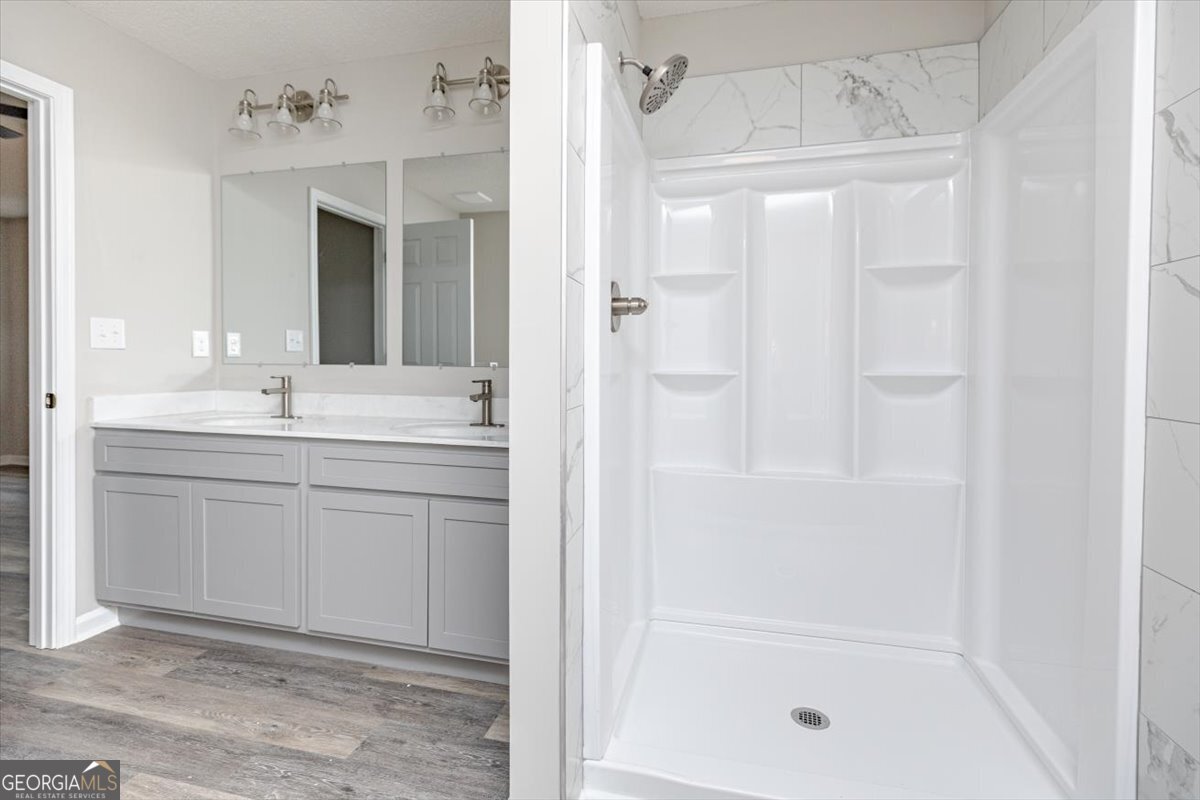 1027 Kathryn Ryals Road Warner Robins, GA 31088 - Photo 34 of 54 a bathroom with a shower sink and mirror