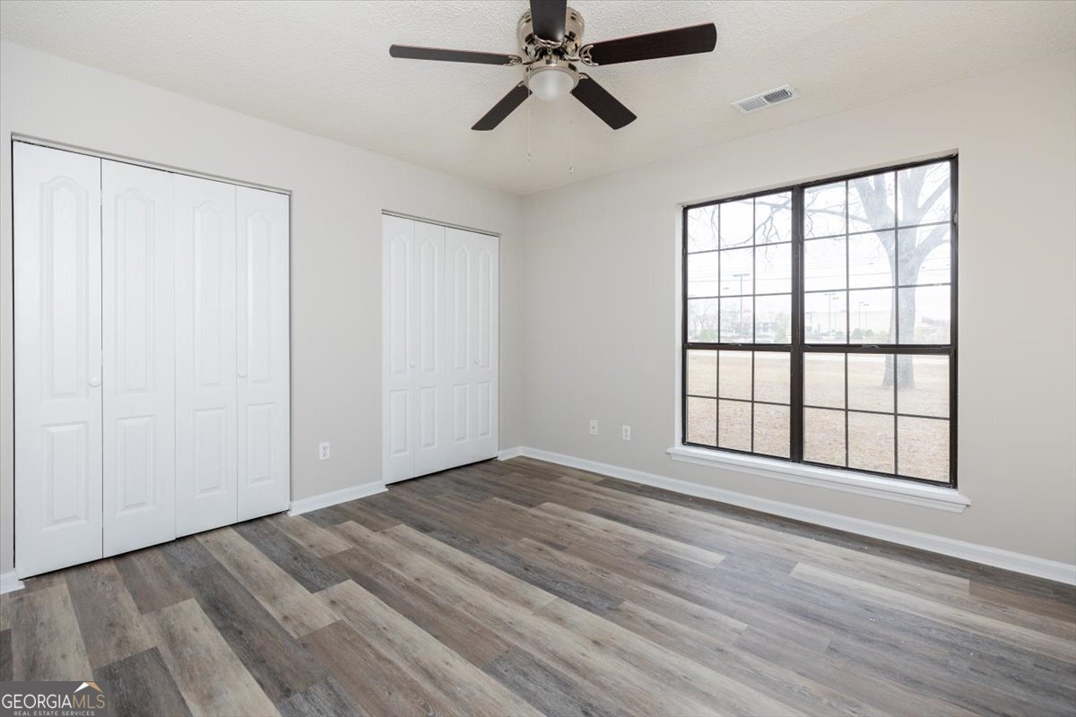 1027 Kathryn Ryals Road Warner Robins, GA 31088 - Photo 41 of 54 wooden floor in an empty room with a window