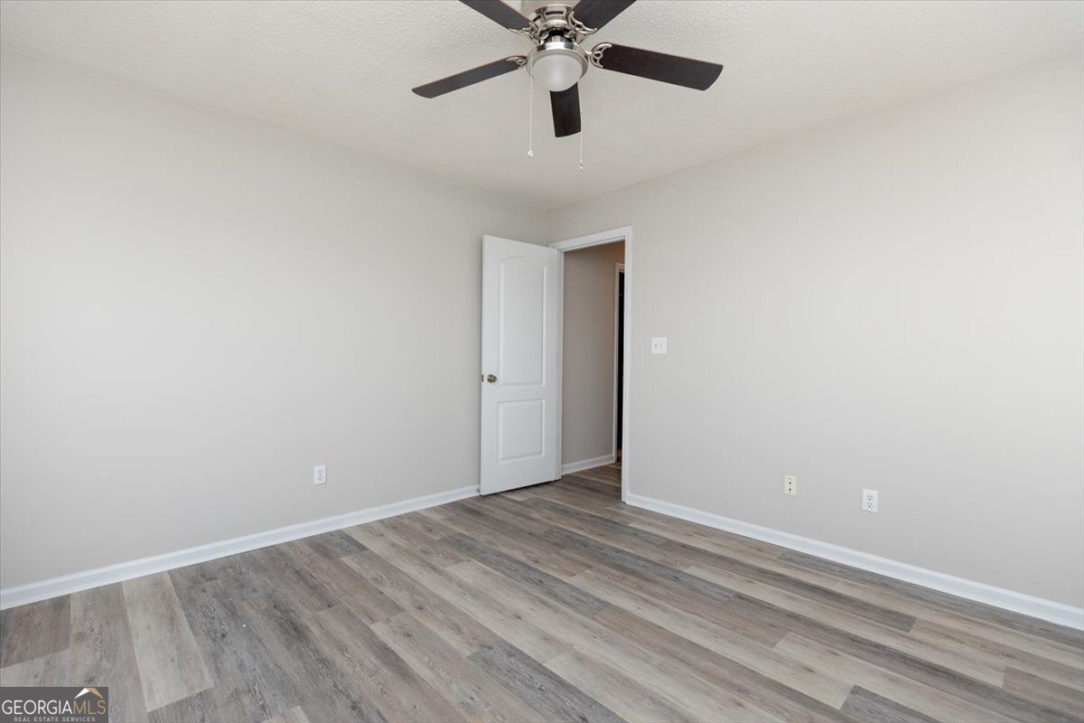 1027 Kathryn Ryals Road Warner Robins, GA 31088 - Photo 42 of 54 a view of an empty room with wooden floor