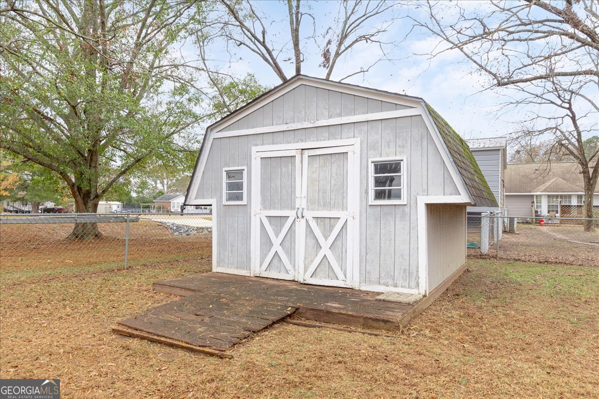 1027 Kathryn Ryals Road Warner Robins, GA 31088 - Photo 54 of 54 a front view of a house with a yard and garage
