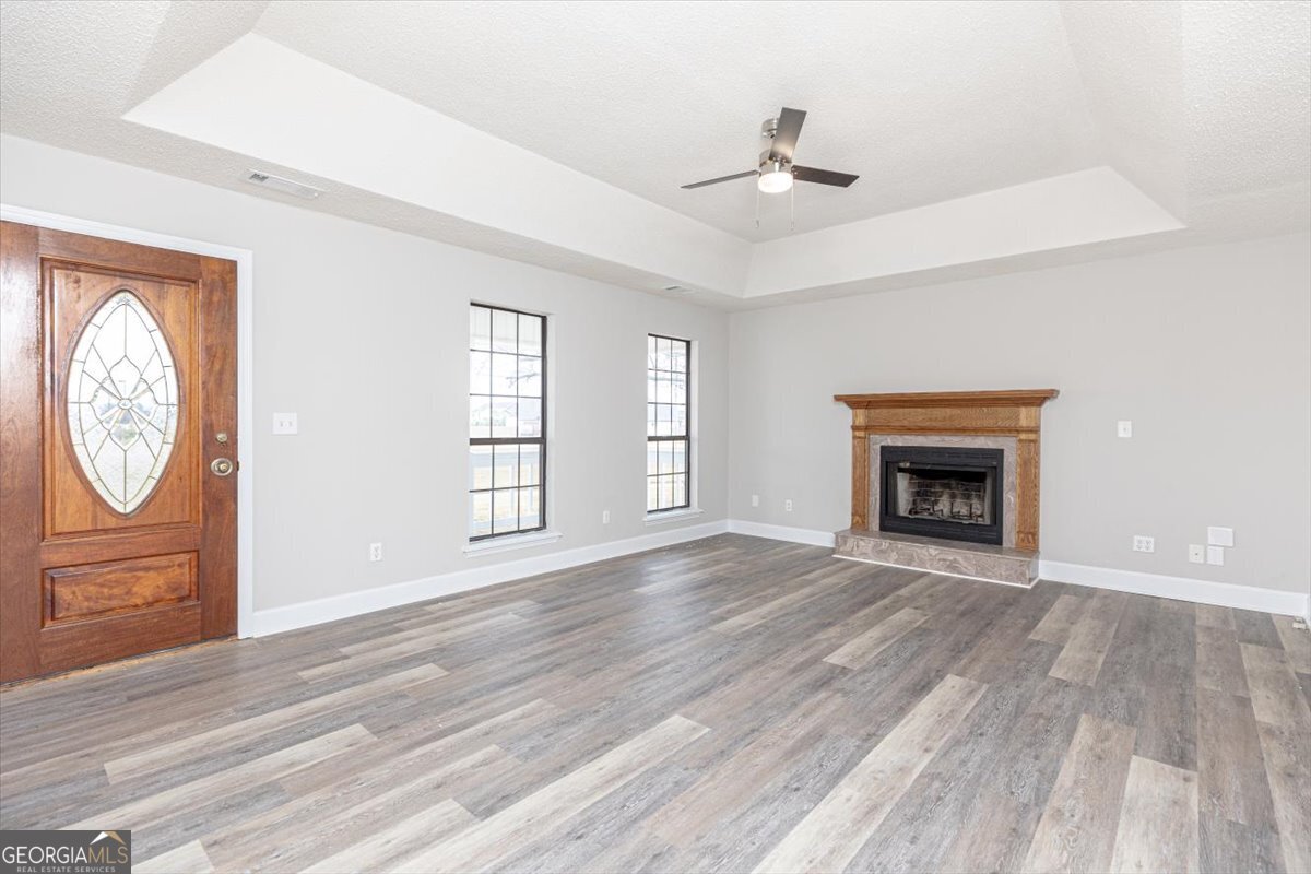 1027 Kathryn Ryals Road Warner Robins, GA 31088 - Photo 10 of 54 a view of an empty room with window and wooden floor