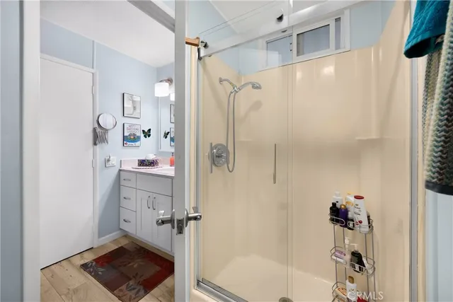 a bathroom with a shower and a sink