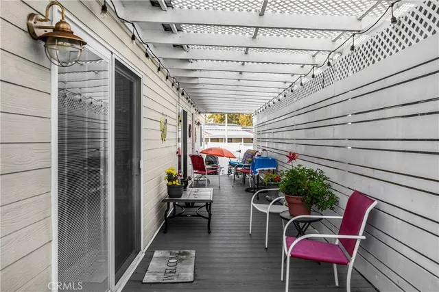 a view of a patio with table and chairs potted plants with wooden floor