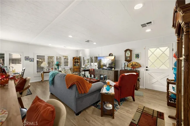 a living room with furniture a rug and a flat screen tv