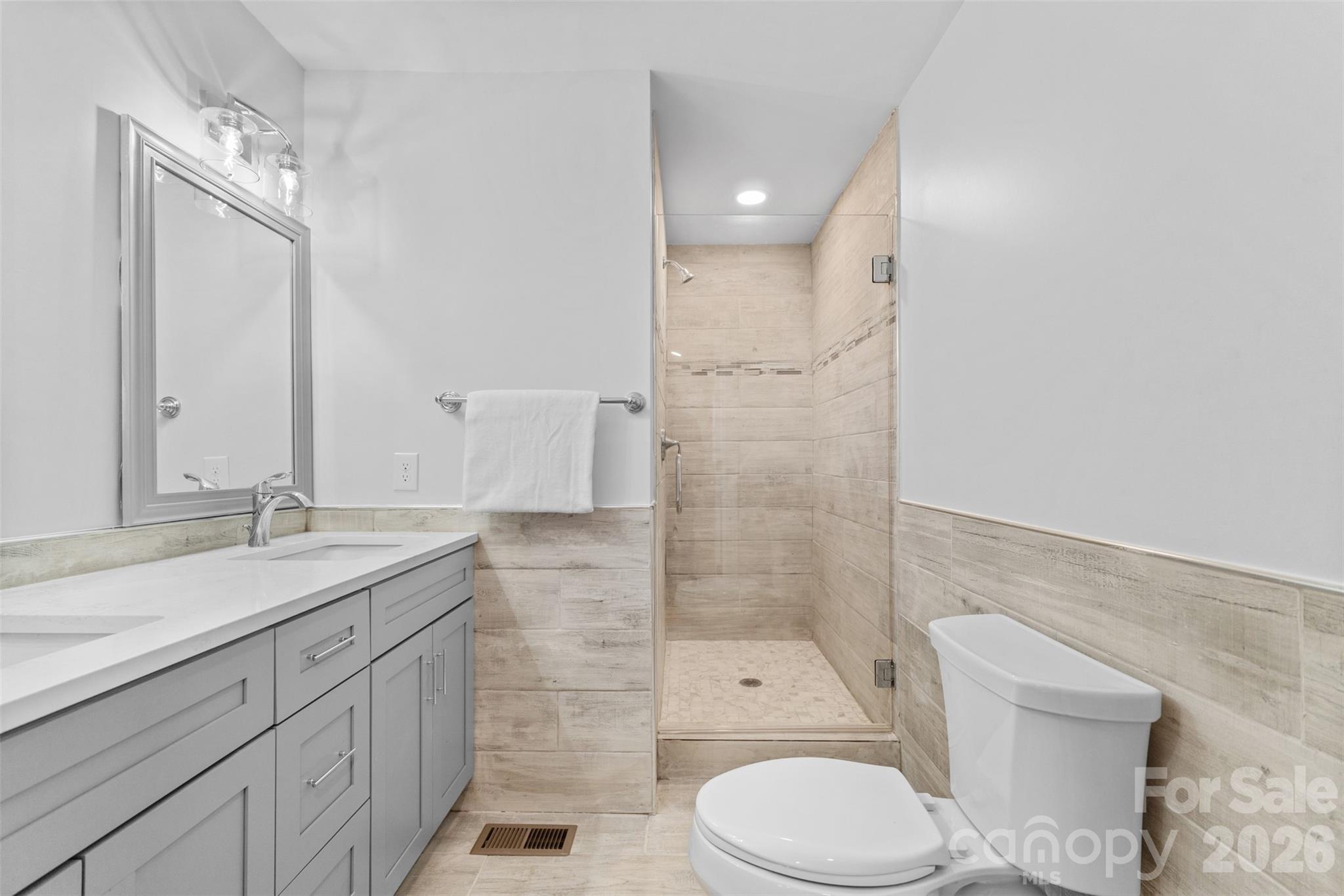 206 Hunter Street York, SC 29745 - Photo 4 of 20 a bathroom with a sink toilet vanity and shower