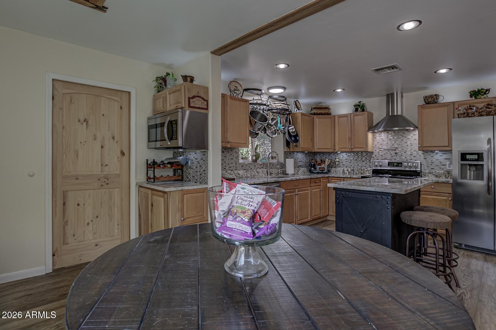 3762 Watertank Road Pine, AZ 85544 - Photo 13 of 38 a kitchen with a refrigerator and cabinets