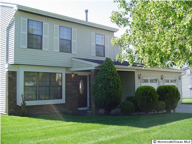 175 Friendship Road Howell, NJ 07731 - Photo 1 of 3 a front view of a house with garden