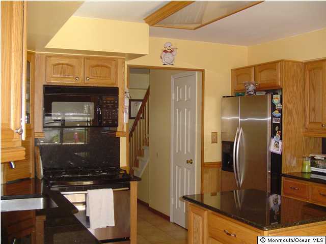 175 Friendship Road Howell, NJ 07731 - Photo 3 of 3 a kitchen with stainless steel appliances granite countertop a refrigerator and a stove