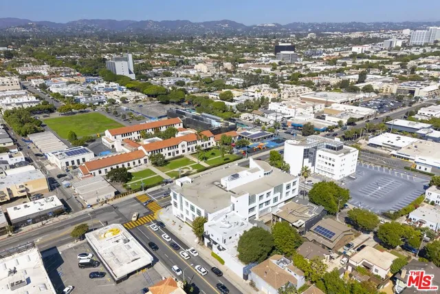 an aerial view of a house with yard and parking