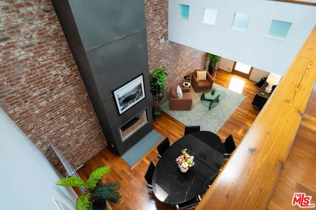 a kitchen with granite countertop a refrigerator stove and wooden floor