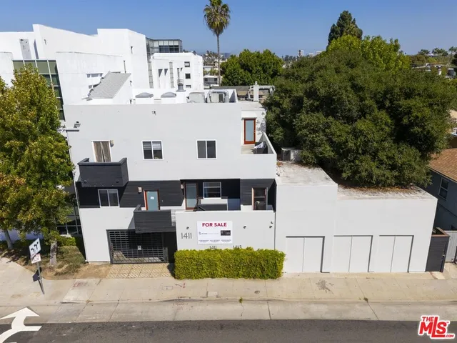a view of a white building with large windows