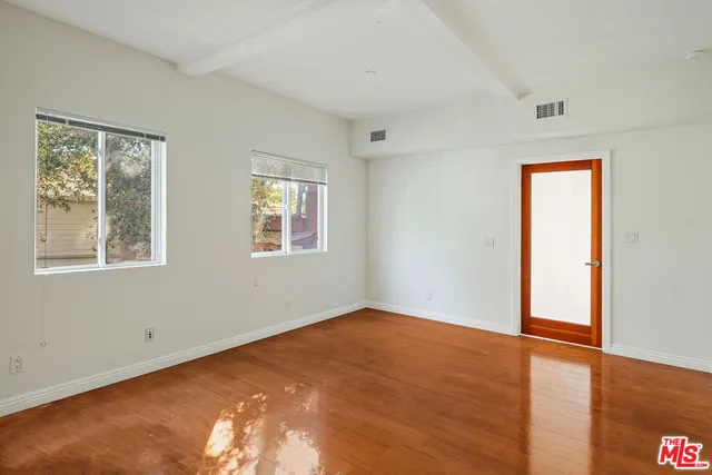 a view of a hallway with wooden walls and a potted plant