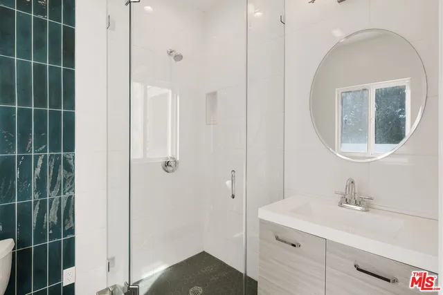 a living room with furniture potted plant and a large window