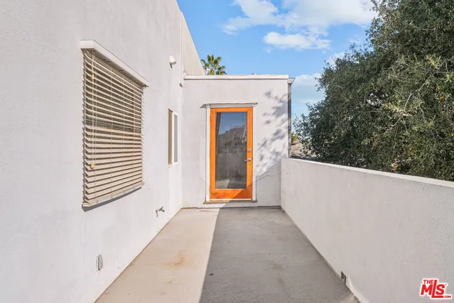 a spacious bedroom with a bed and wooden floor