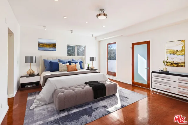 a kitchen with stainless steel appliances granite countertop a refrigerator a stove and a sink with wooden floor