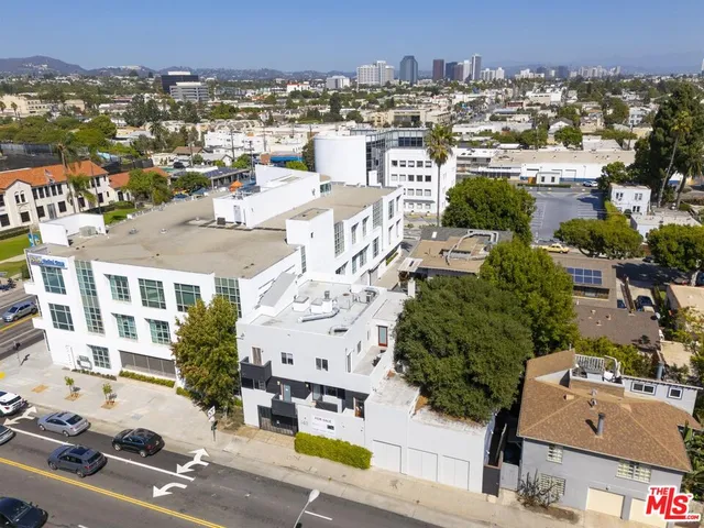 an aerial view of residential houses with city view