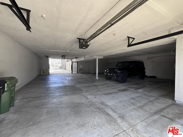 an aerial view of residential houses with cars parked on the roadside