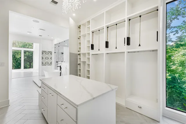a living room with furniture chandelier and a fireplace
