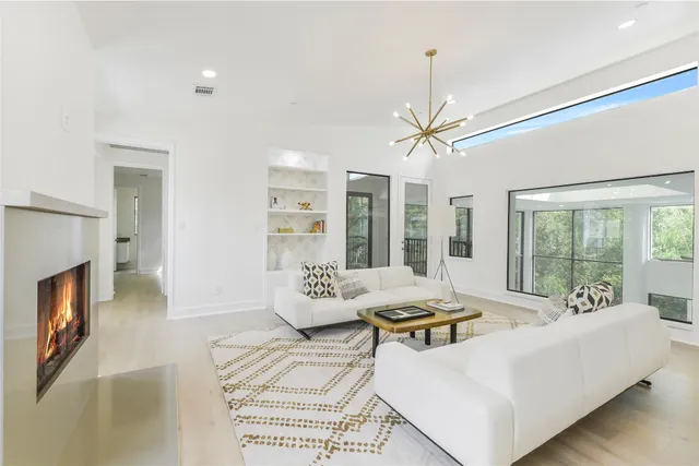 a living room with furniture a fireplace and a table