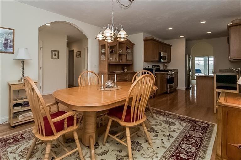 80 Brookside Road, Unit 205 Bourne, MA 02532 - Photo 13 of 35 a dining room with furniture a chandelier and wooden floor