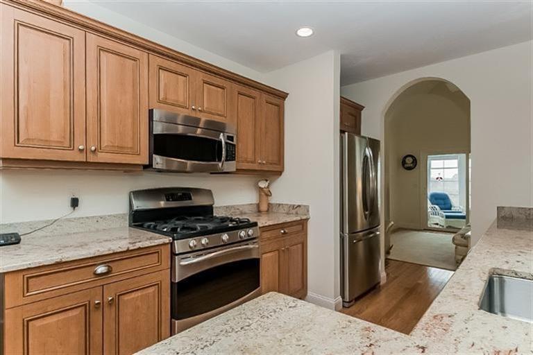 80 Brookside Road, Unit 205 Bourne, MA 02532 - Photo 16 of 35 a kitchen with stainless steel appliances granite countertop a refrigerator stove and sink