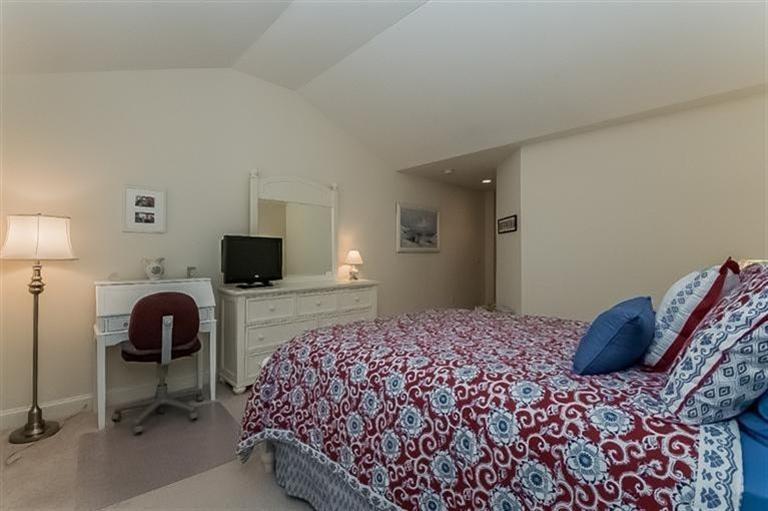 80 Brookside Road, Unit 205 Bourne, MA 02532 - Photo 18 of 35 a bedroom with a bed and a flat screen tv