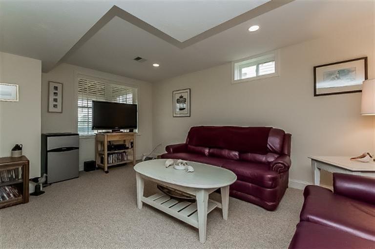 80 Brookside Road, Unit 205 Bourne, MA 02532 - Photo 25 of 35 a living room with furniture and a flat screen tv