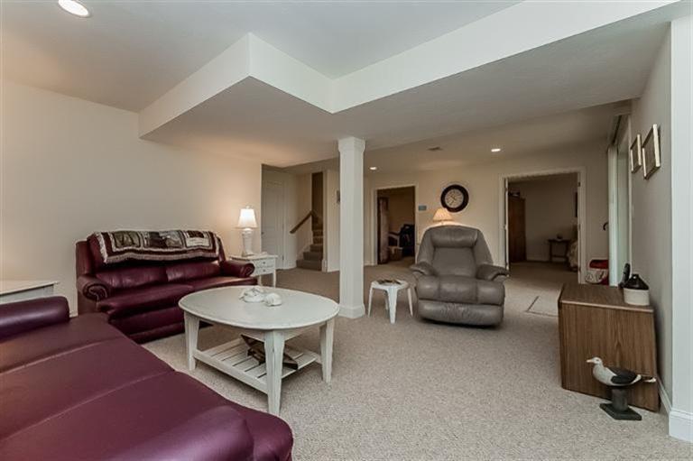 80 Brookside Road, Unit 205 Bourne, MA 02532 - Photo 26 of 35 a living room with furniture a table and a piano