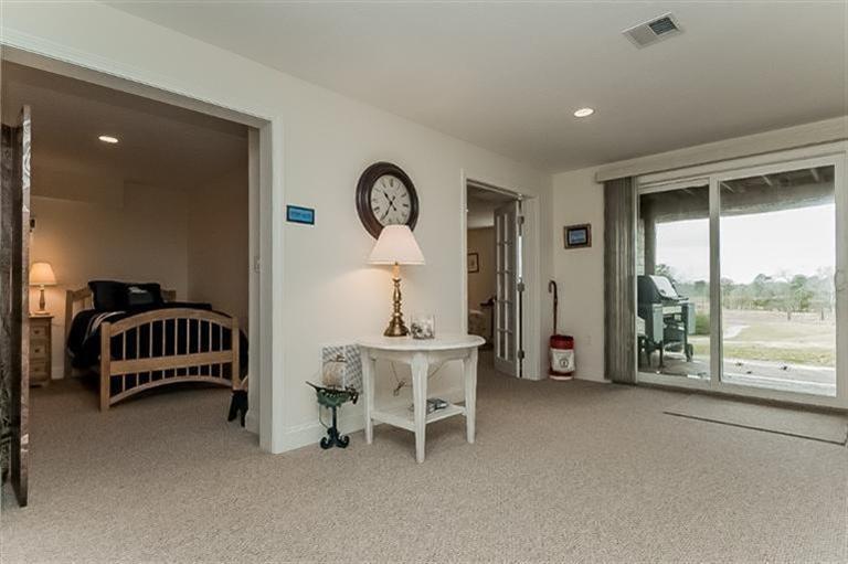 80 Brookside Road, Unit 205 Bourne, MA 02532 - Photo 27 of 35 a living room with a window and a chandelier