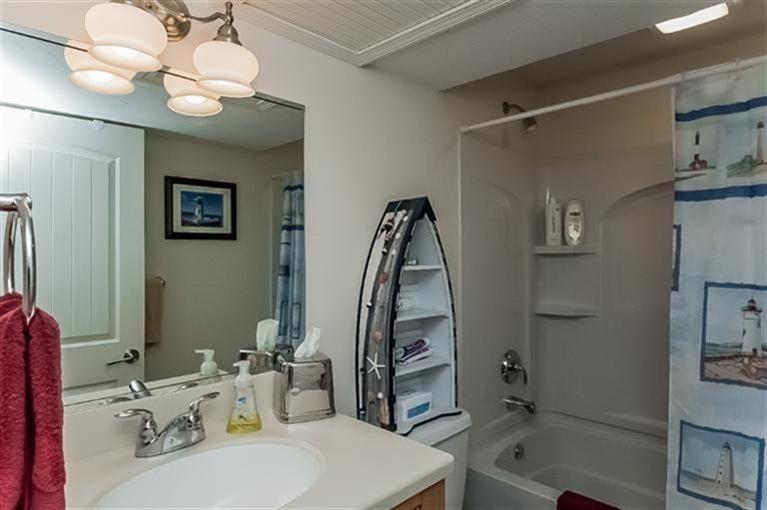 80 Brookside Road, Unit 205 Bourne, MA 02532 - Photo 30 of 35 a bathroom with a sink a toilet and shower