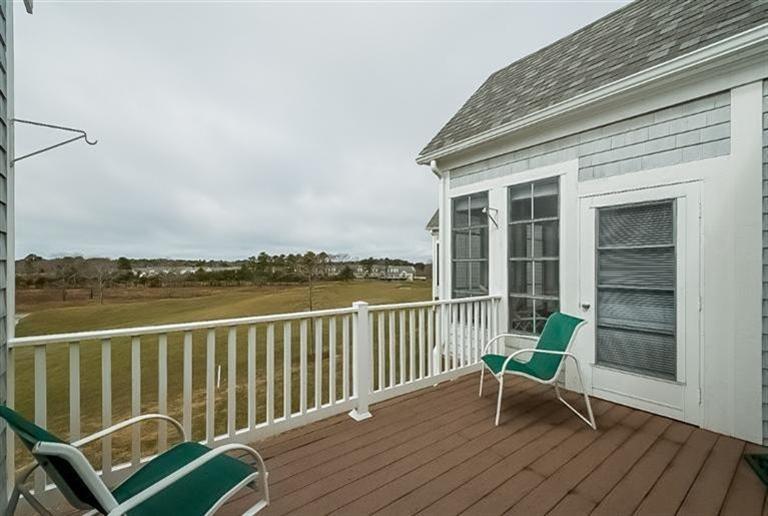 80 Brookside Road, Unit 205 Bourne, MA 02532 - Photo 31 of 35 a view of a chair and table on the deck