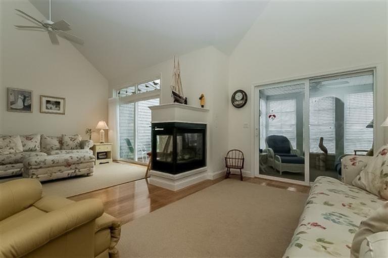 80 Brookside Road, Unit 205 Bourne, MA 02532 - Photo 5 of 35 a living room with furniture and a fireplace