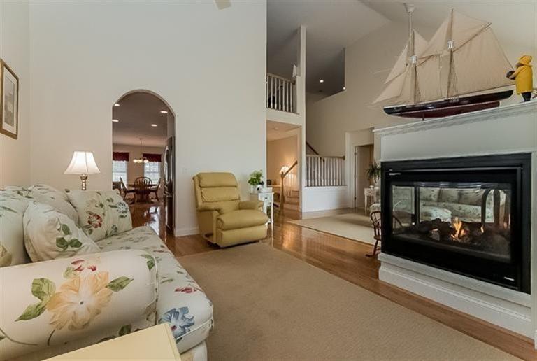 80 Brookside Road, Unit 205 Bourne, MA 02532 - Photo 9 of 35 a living room with furniture and a fireplace