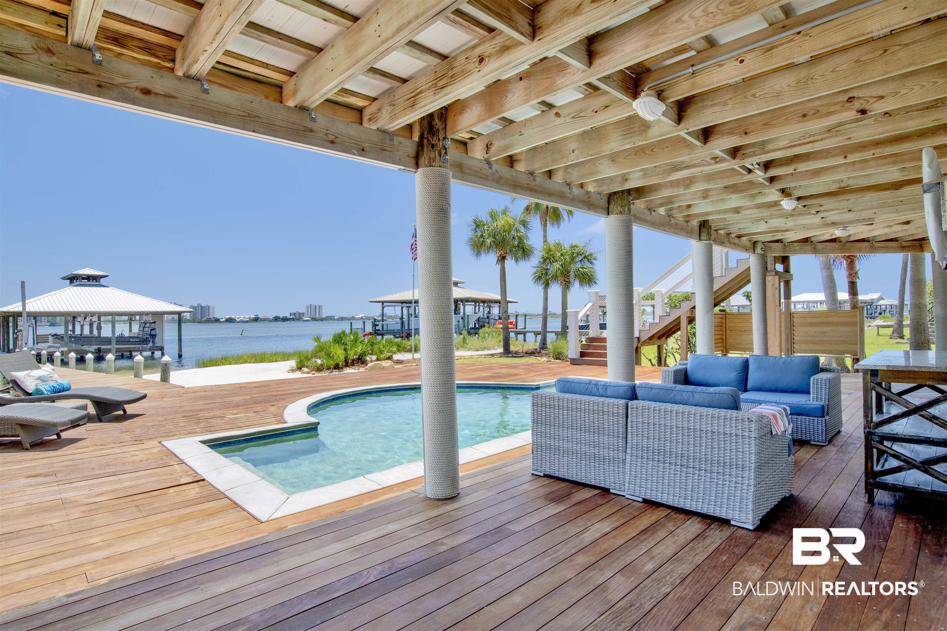 33400 River Road Orange Beach, AL 36561 - Photo 13 of 72 View of swimming pool with an outdoor living space and a deck with water view