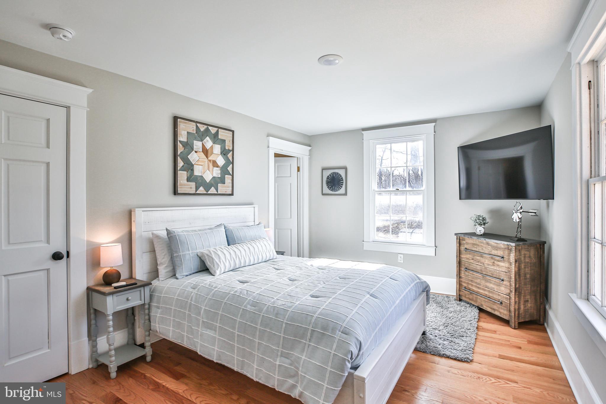 17345 Raven Rocks Road Bluemont, VA 20135 - Photo 56 of 99 a bedroom with a large bed and a flat screen tv