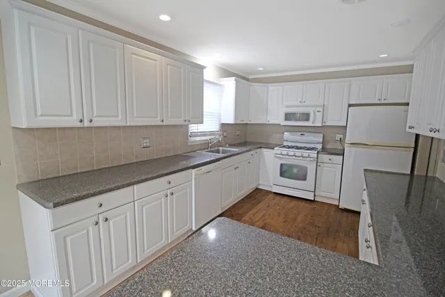 a kitchen with a sink a stove and refrigerator