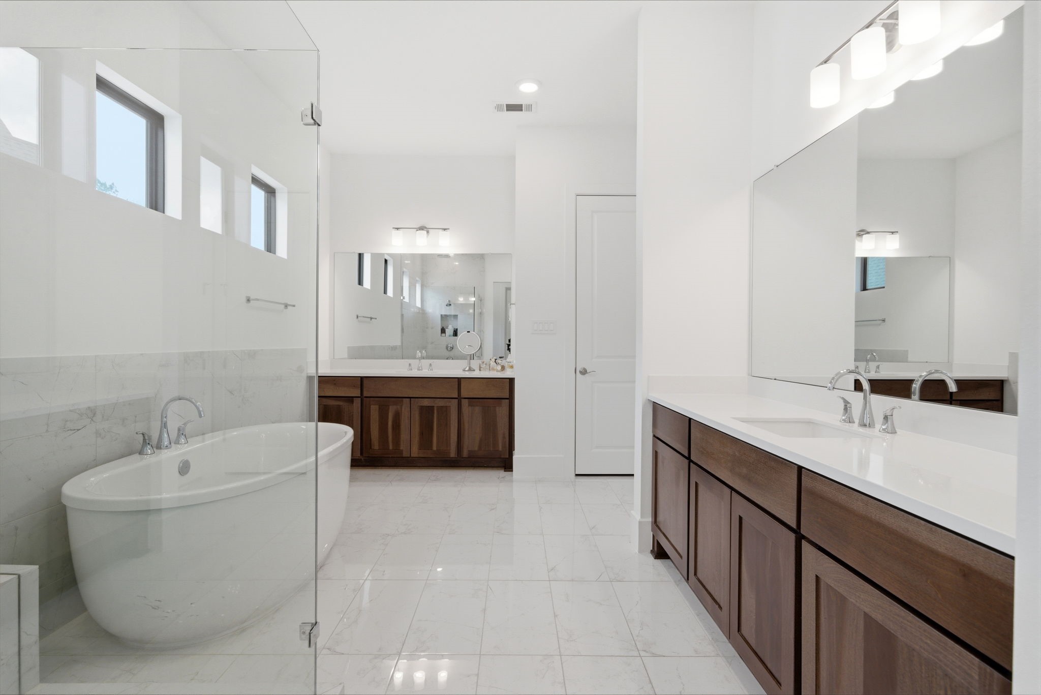 4906 Lagos Lagoon Way Spring, TX 77389 - Photo 11 of 26 a bathroom with a double vanity sink a mirror and a bathtub