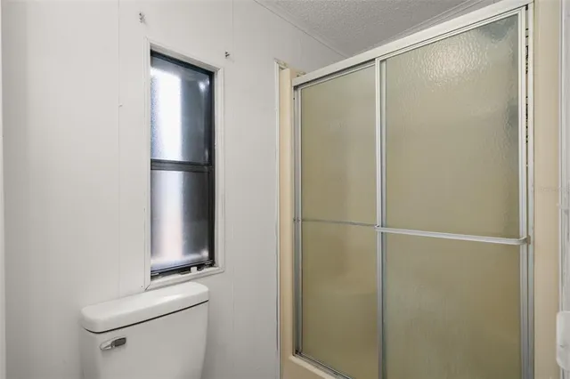 a bathroom with a shower and a toilet
