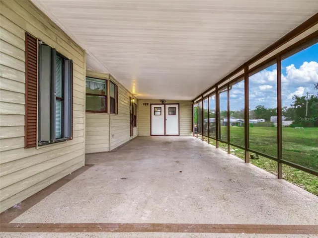 a view of a hallway with a couch and a window