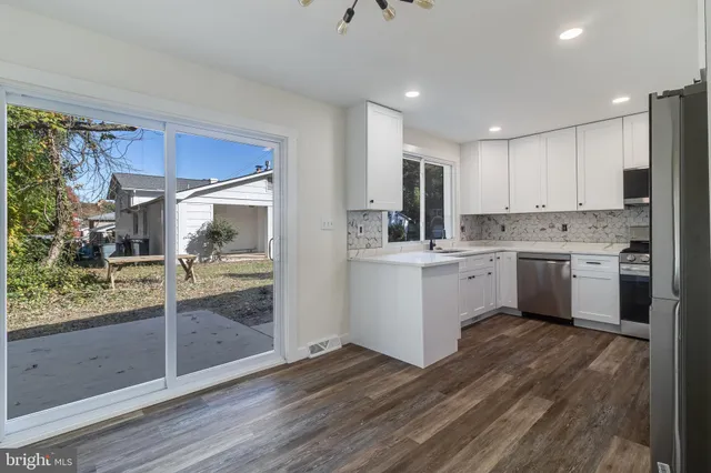 a kitchen with stainless steel appliances a stove sink microwave and cabinets
