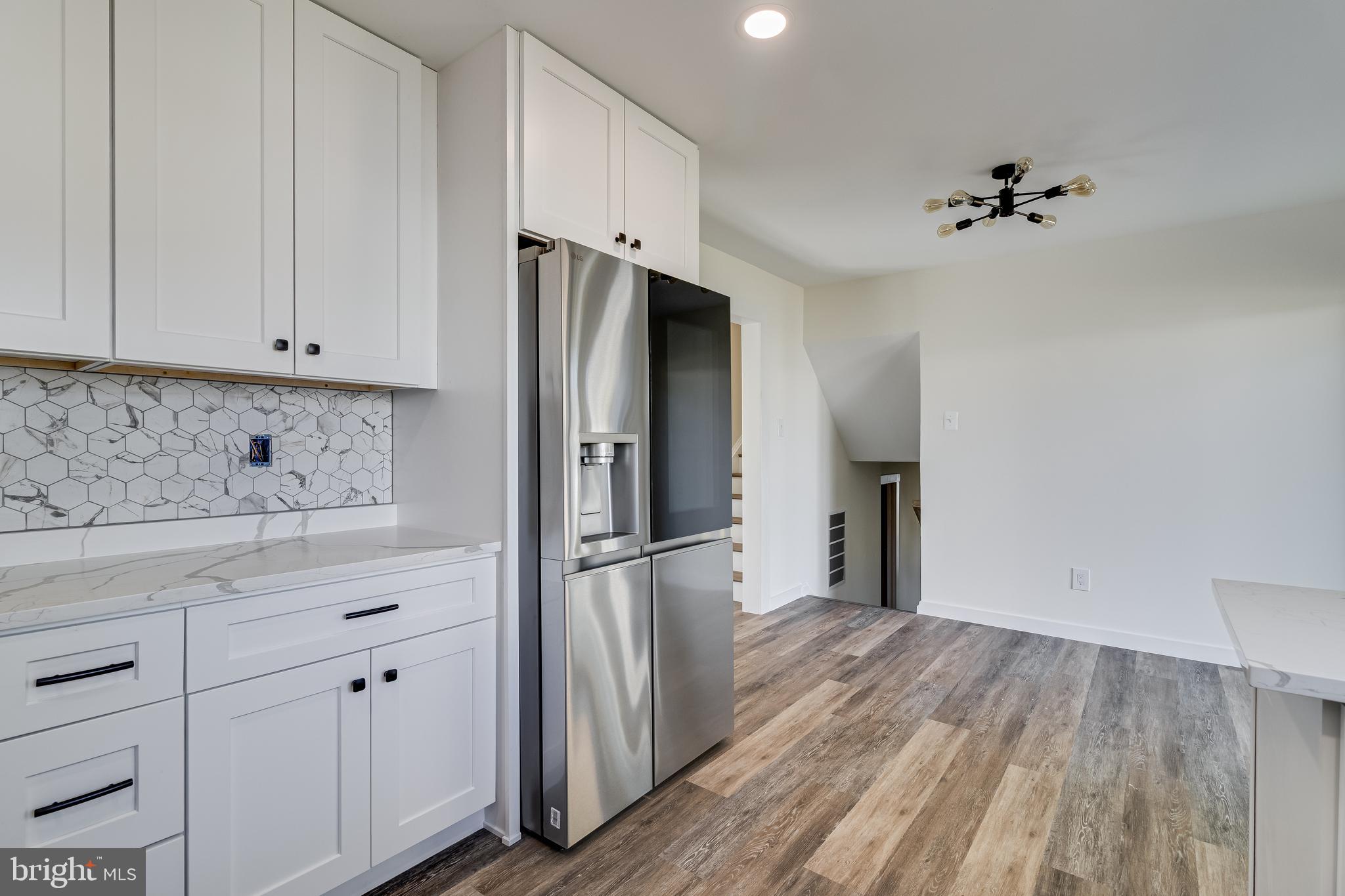 2804 Testway Avenue Fort Washington, MD 20744 - Photo 15 of 36 a kitchen with a refrigerator and white cabinets