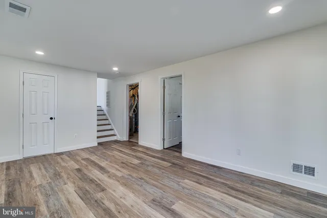 a view of a livingroom with wooden floor and a window