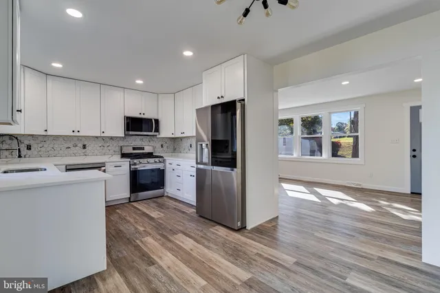 a kitchen with cabinets stainless steel appliances and a counter space