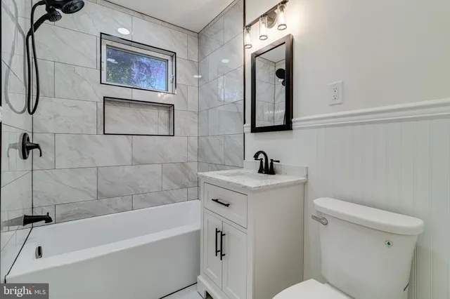 a bathroom with a sink a toilet and mirror